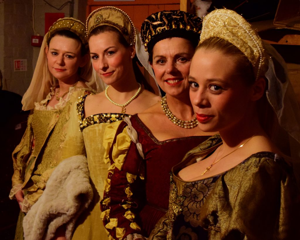 Four smiling ladies in Tudor dress